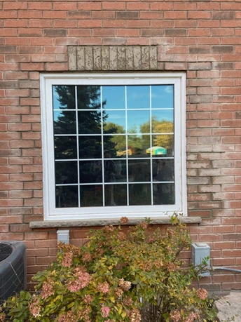 New grid-style vinyl window installation on brick home exterior by Wilworks Renovations in Durham Region