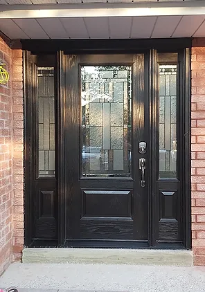 Black front entry door with decorative glass sidelights installed by Wilworks Renovations in Durham Region