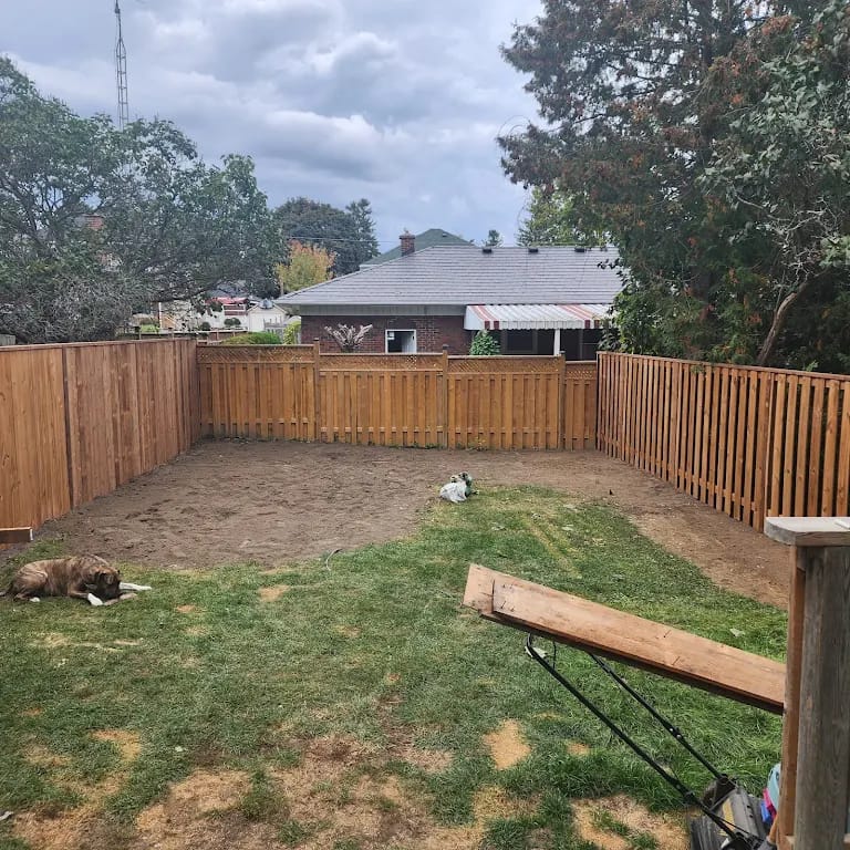 Oshawa Wood Fence Installation – Wilworks Renovations Wood fence installed in Oshawa backyard with alternating picket pattern and dog run in progress