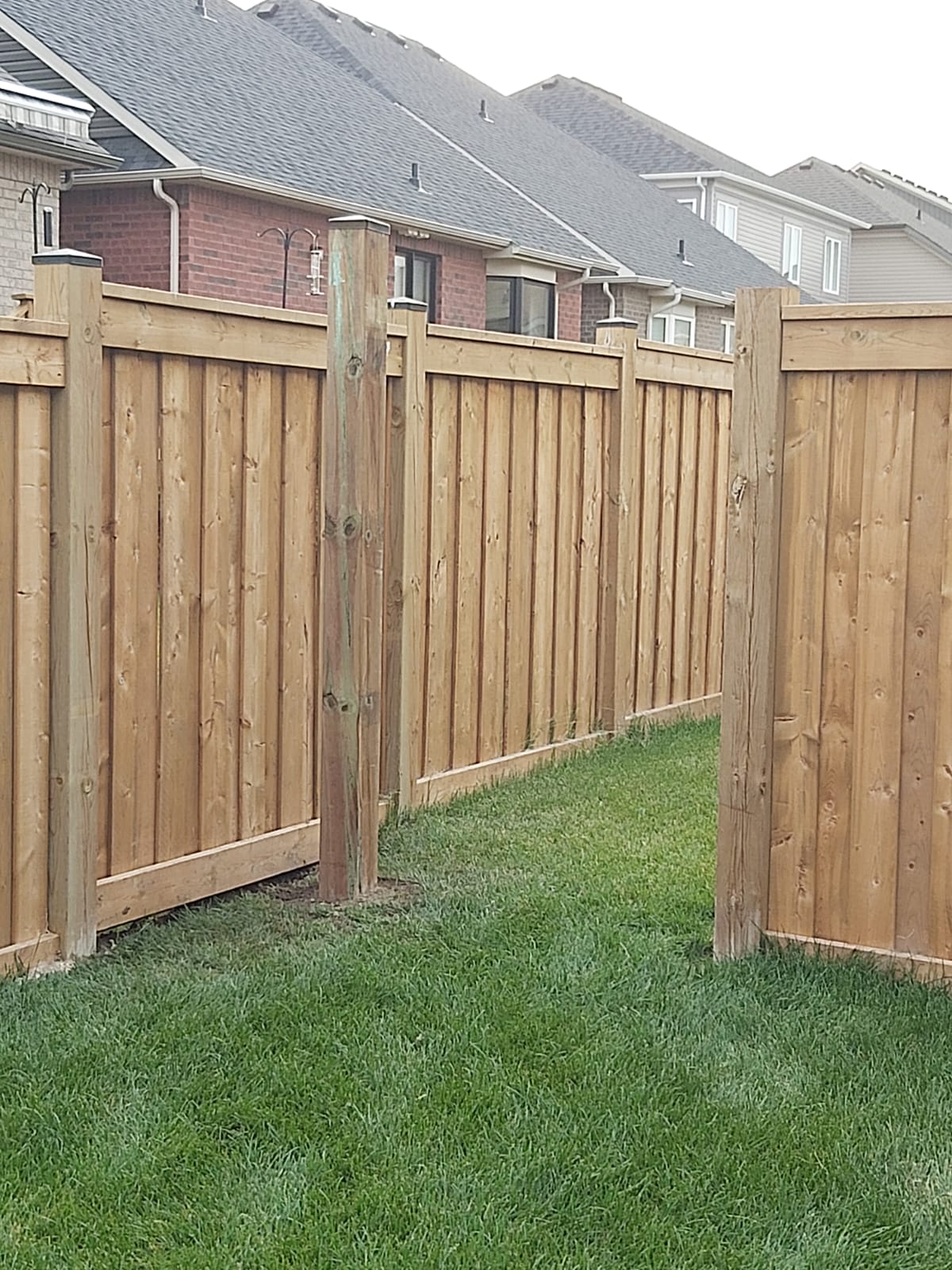 Wood fence with open post gap for future gate installation in Oshawa subdivision backyard