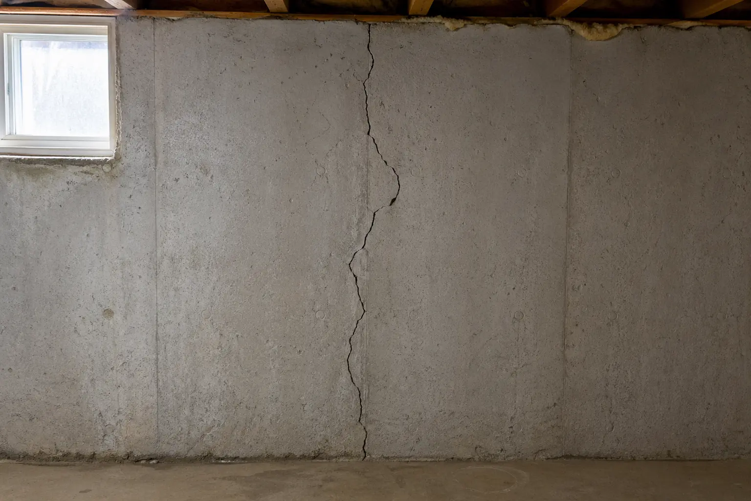 Diagonal foundation crack in a poured concrete basement wall in an Oshawa home